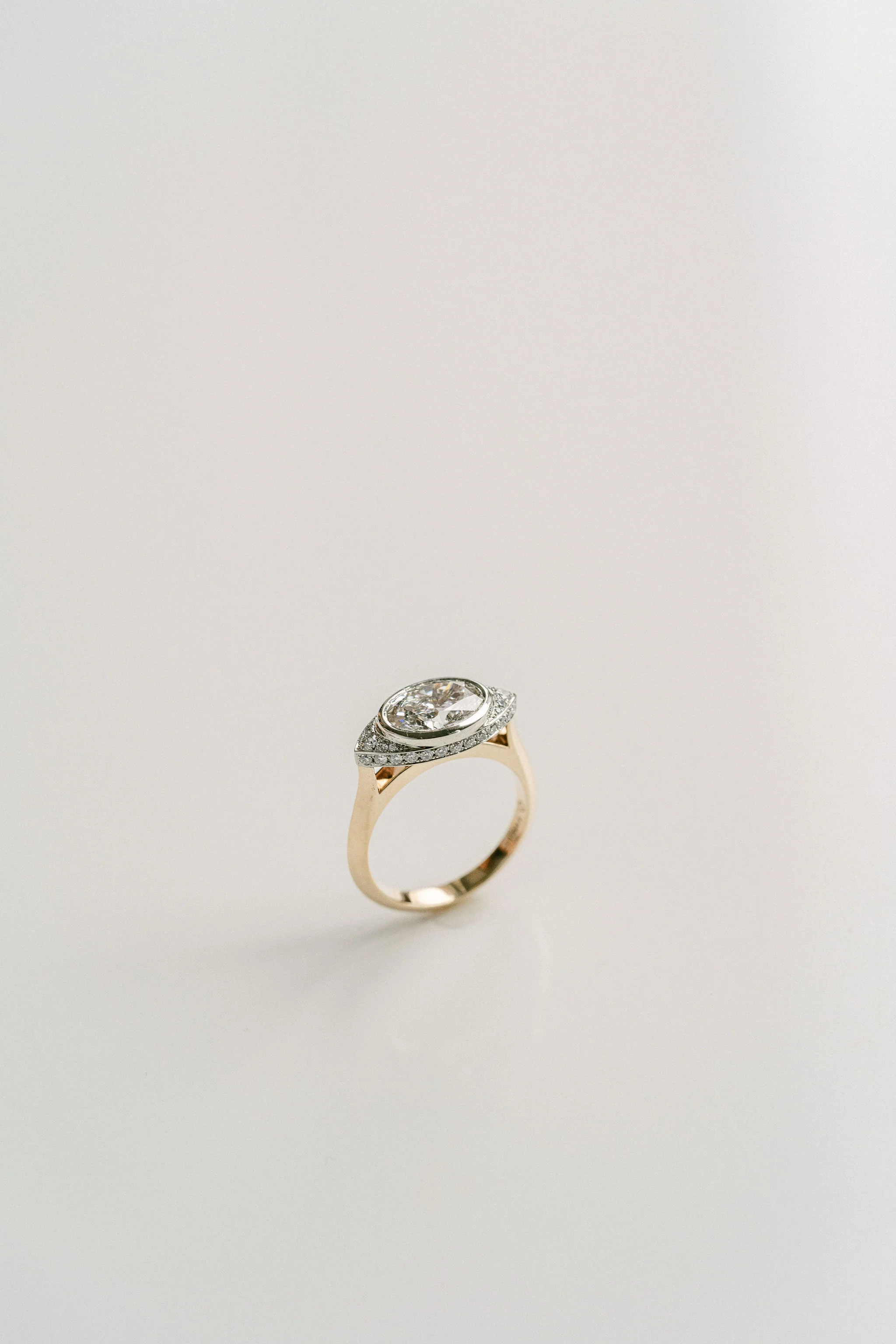 Oval Diamond Two Tone Ring With Diamond Eye Halo - Image 4